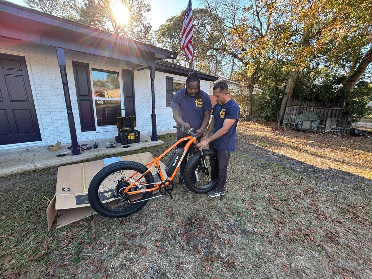 Helpful Hands team assembling an electric fat-tire bike